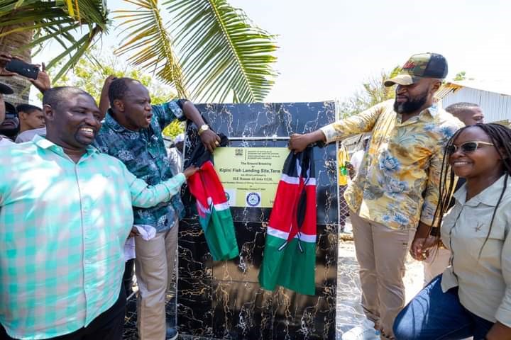 Cabinet Secretary Hon. Hassan Ali Joho unveils a commemorative plaque after breaking the ground for the Kipini Landing Site infrastructure upgrade accompanied by Principal Secretary Betsy Njagi Governor Dhadho Gaddae Godhana (2nd left).